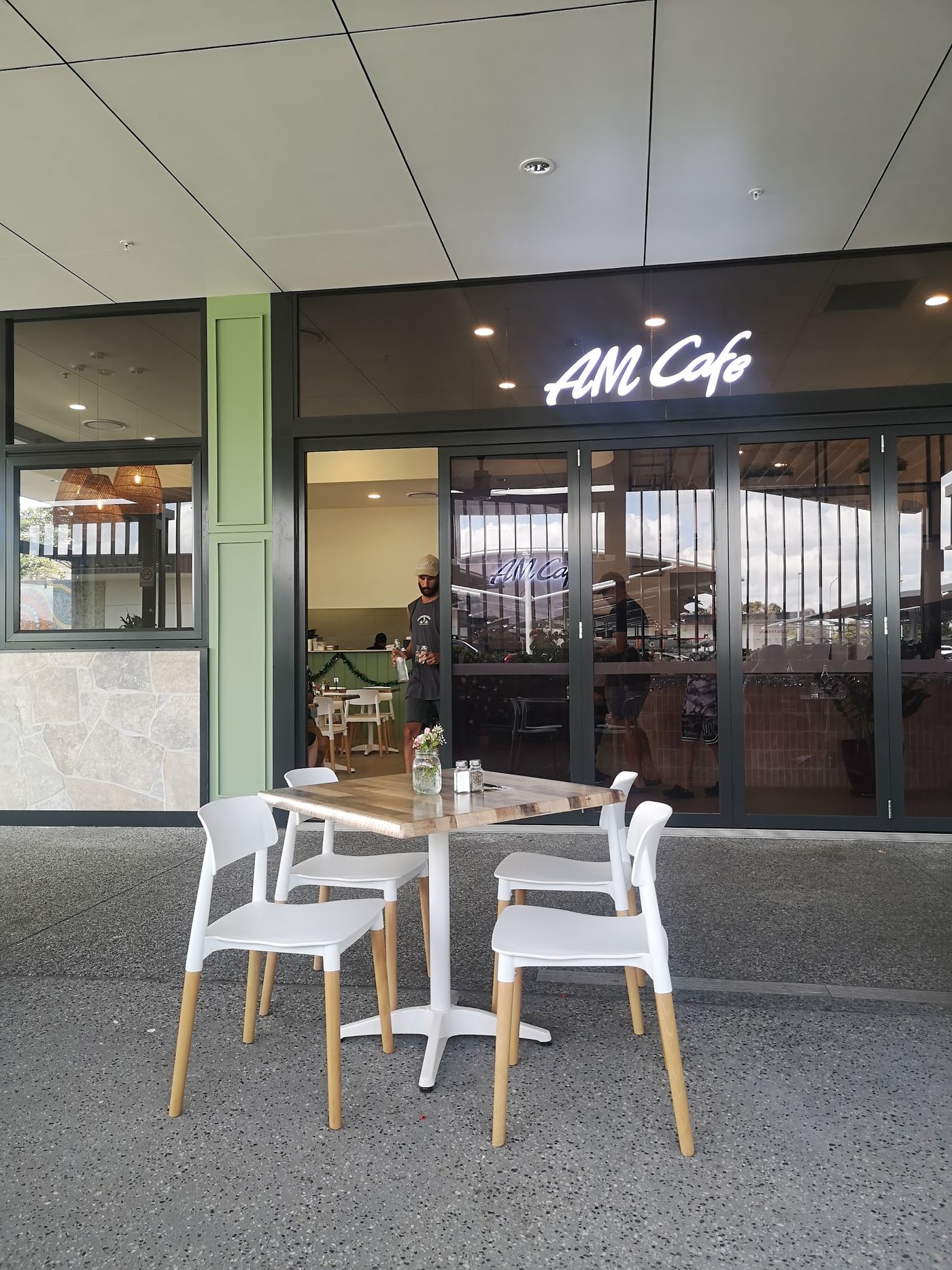 AM Cafe shopfront with outdoor table and chairs