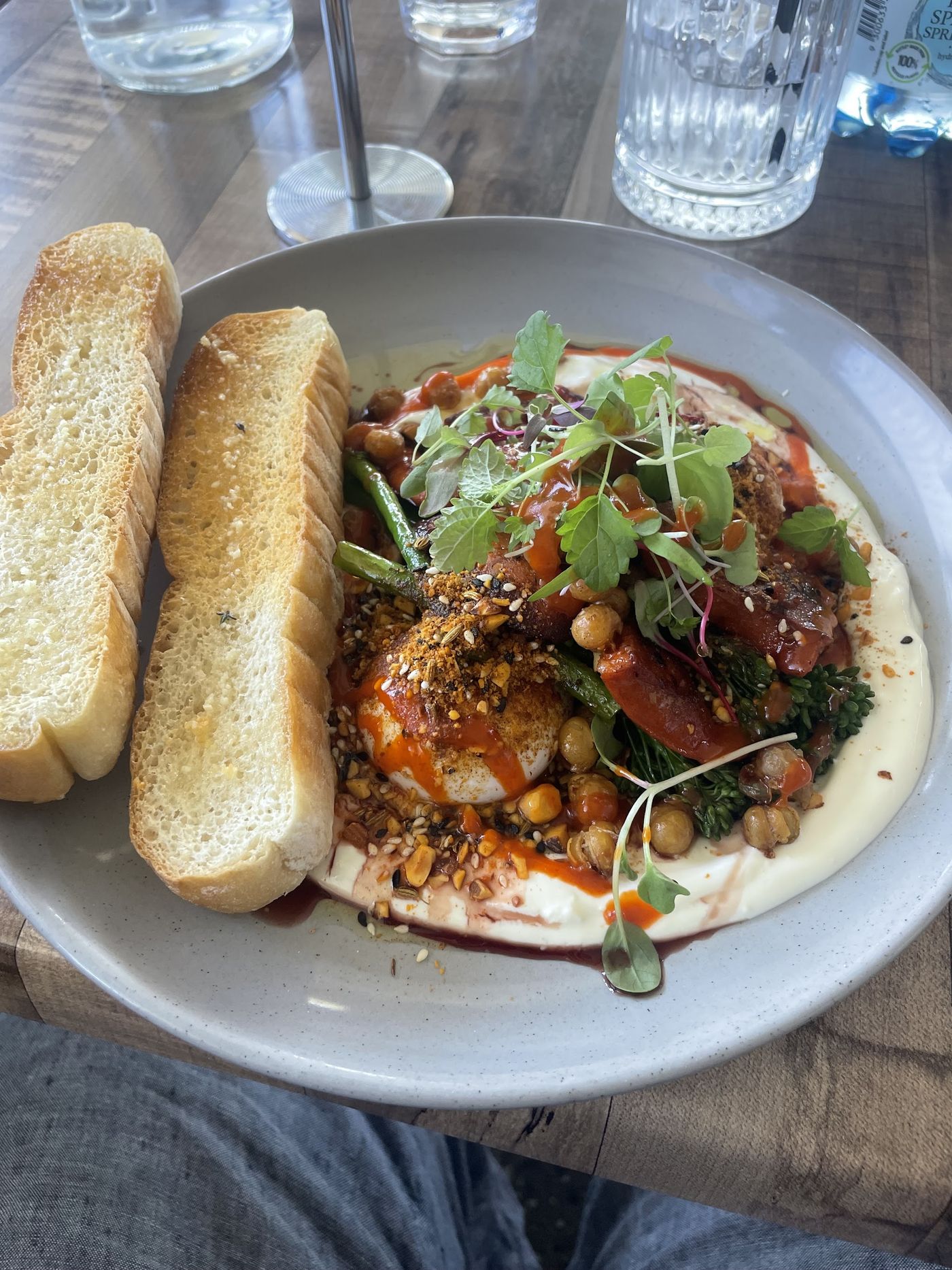 Baked eggs with hummus, chickpeas, broccolini and dukkah with toast
