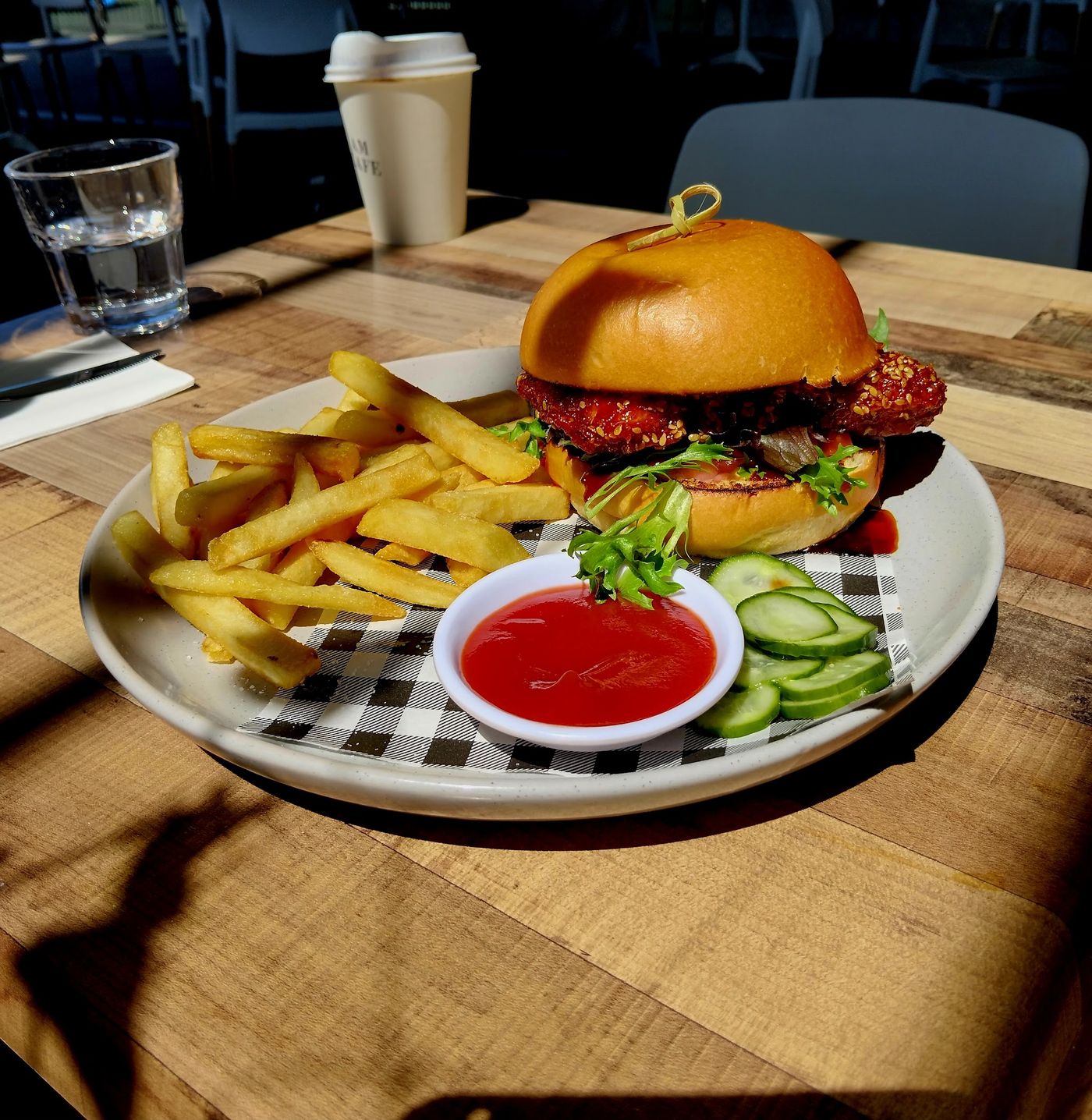 Glazed chicken burger with chips and tomato sauce